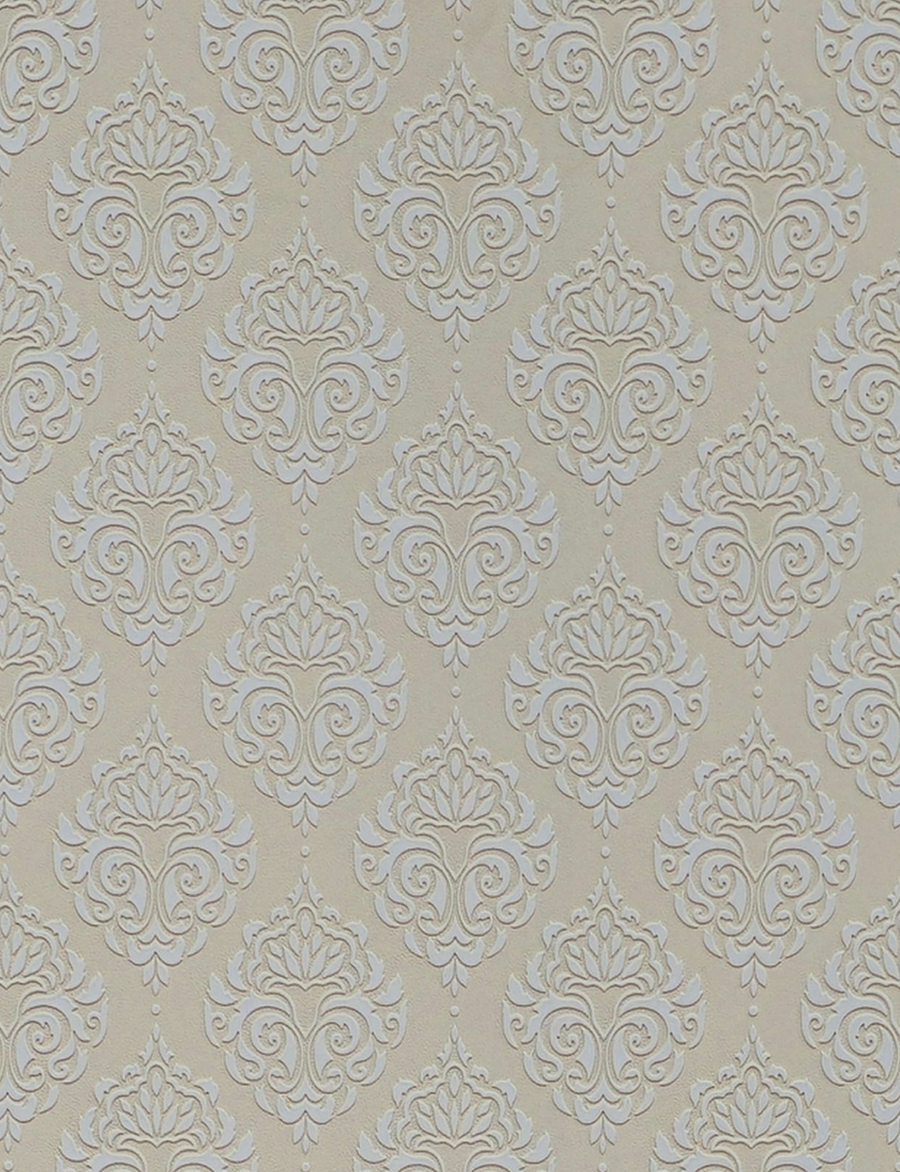 Beige wall panel with white embossed damask pattern and textured finish.