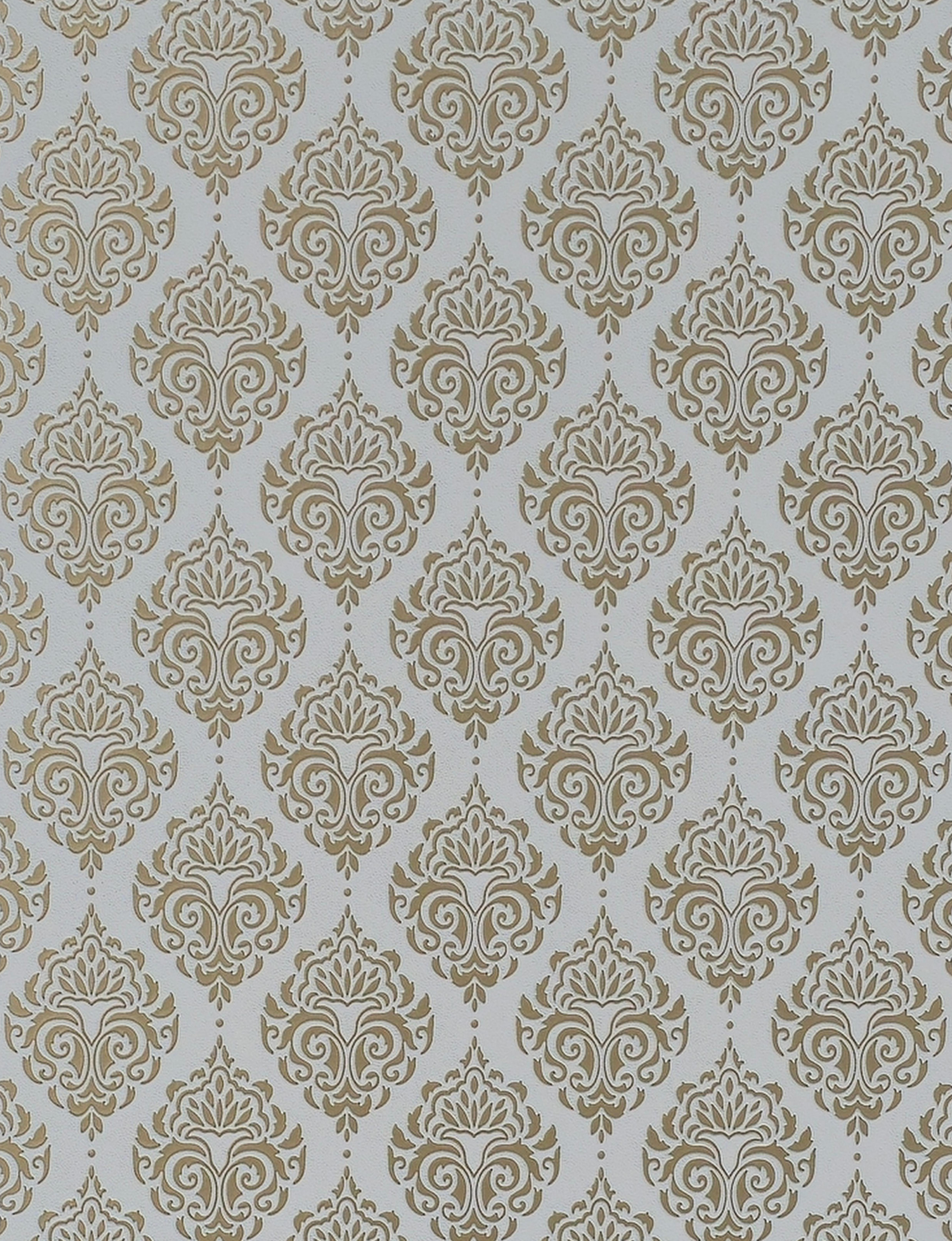 Gold damask pattern on white textured wall panel with intricate floral design.
