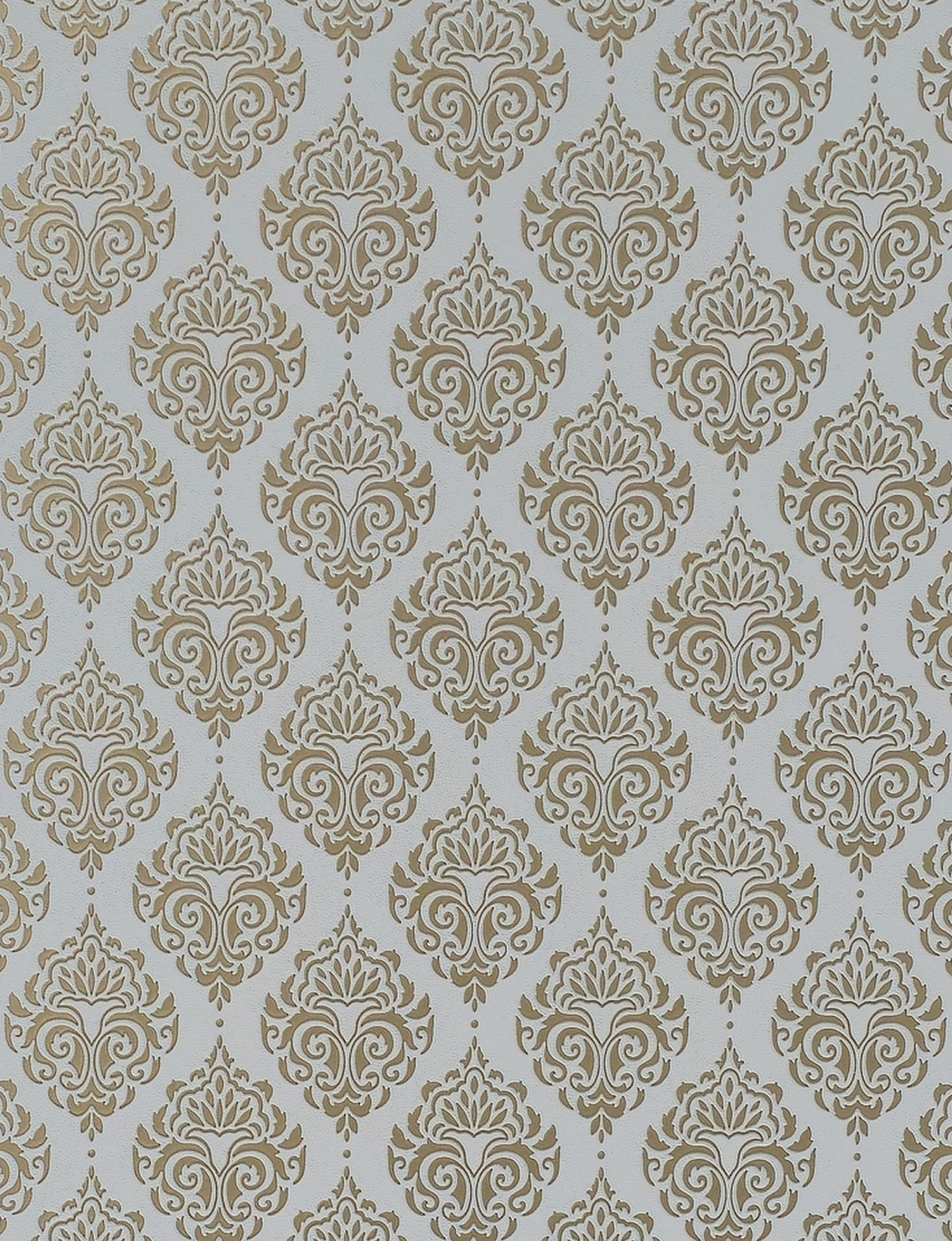 Gold damask pattern on white textured wall panel with intricate floral design.