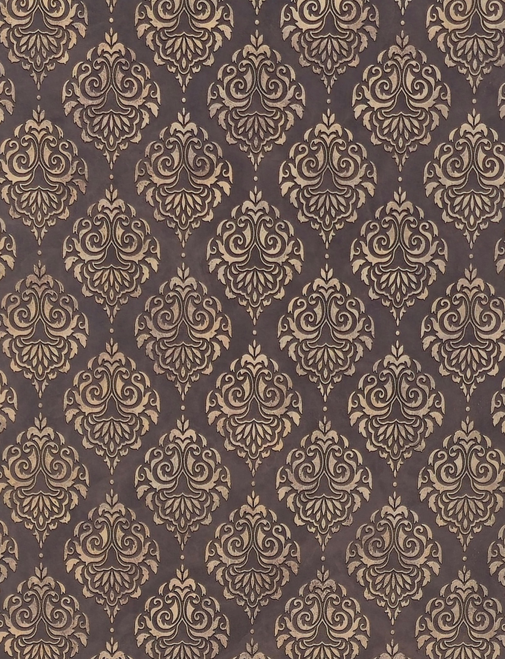 Brown wall panel with repeating gold damask pattern and textured finish.