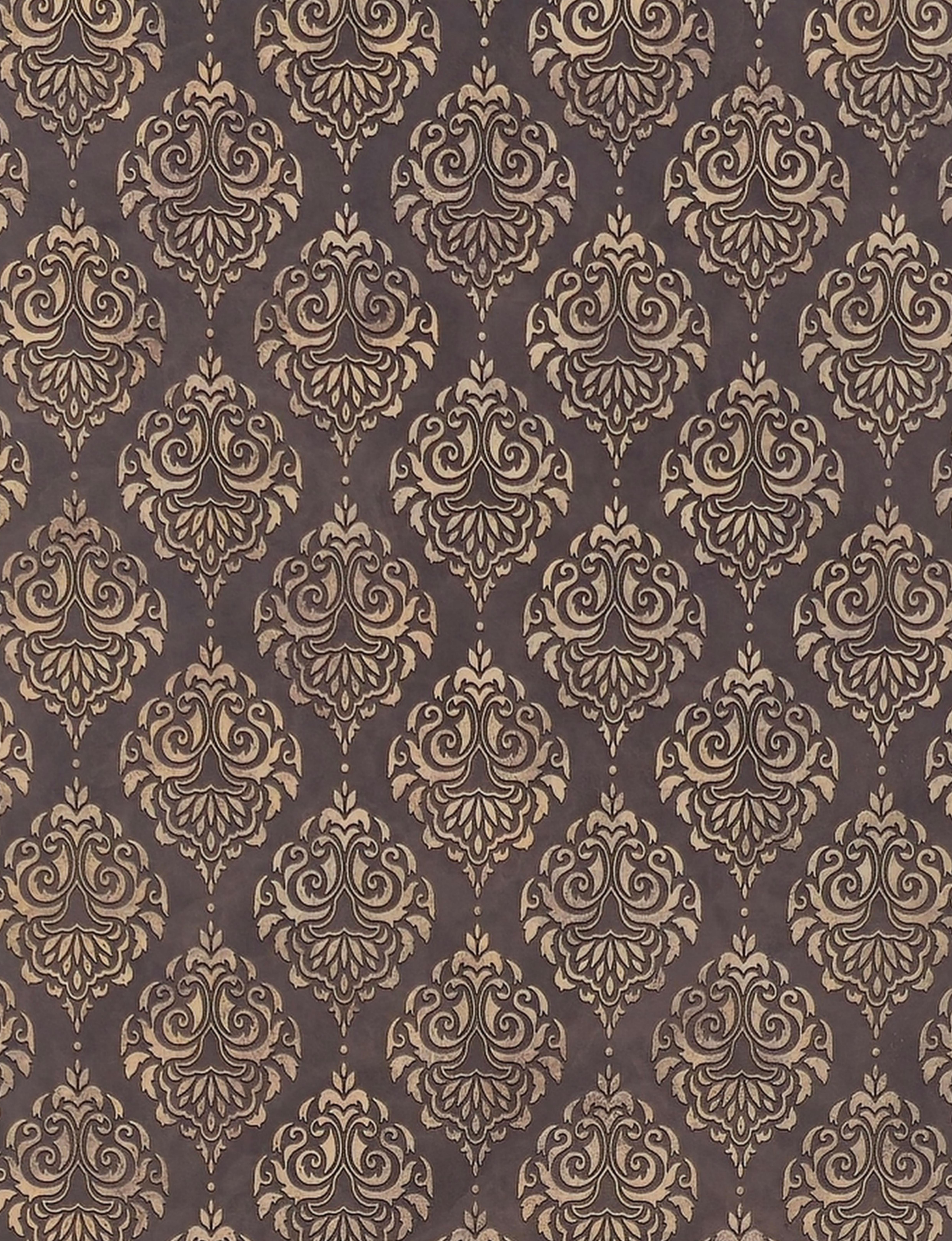 Brown wall panel with repeating gold damask pattern and textured finish.
