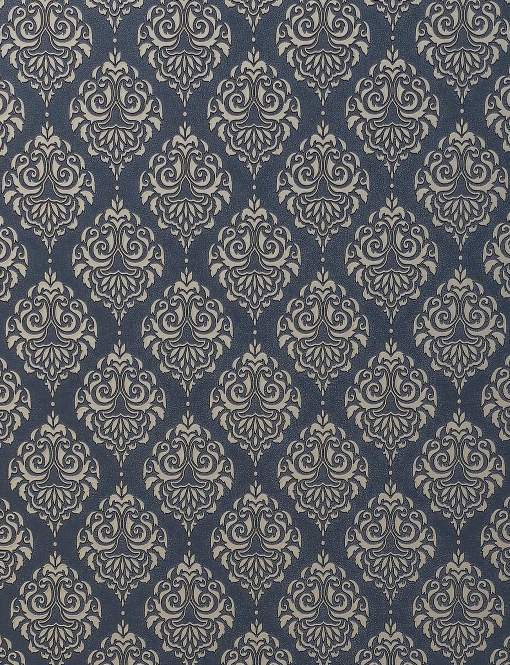 Dark blue wall panel with beige damask pattern and textured finish.
