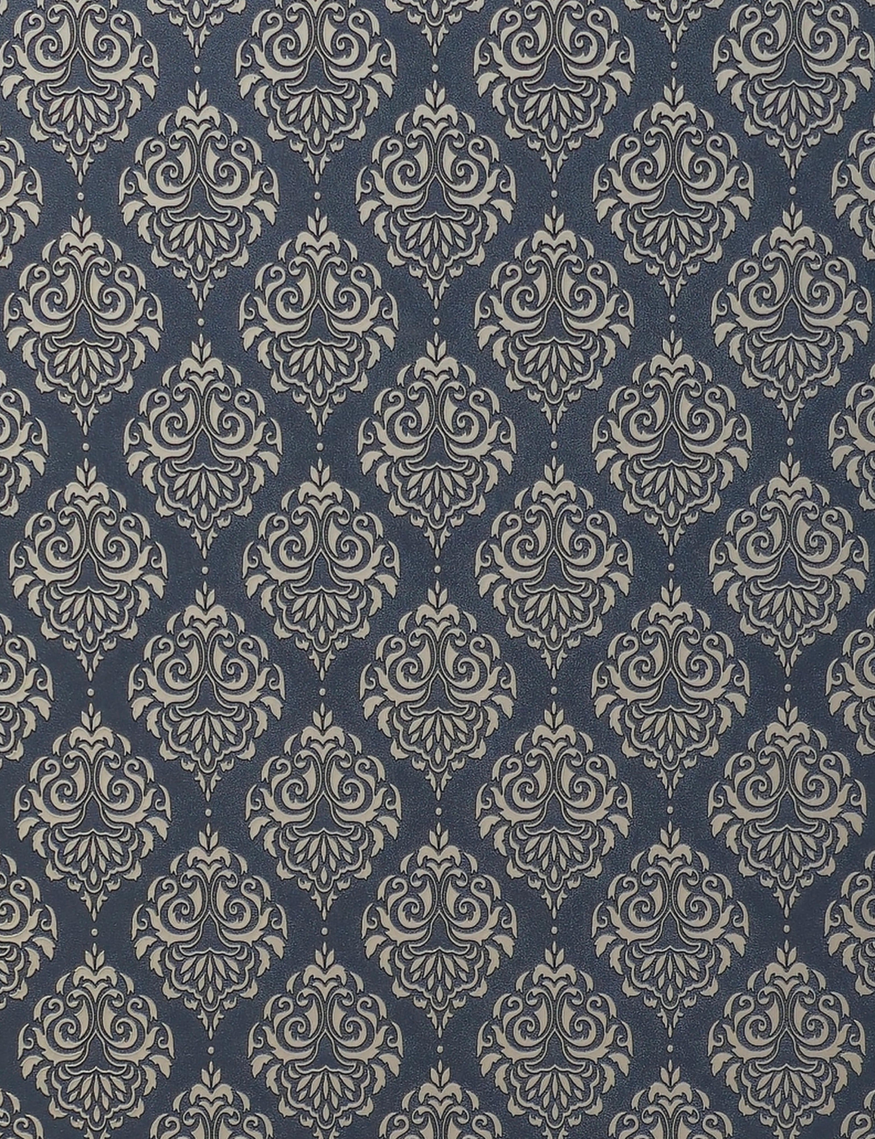 Dark blue wall panel with beige damask pattern and textured finish.