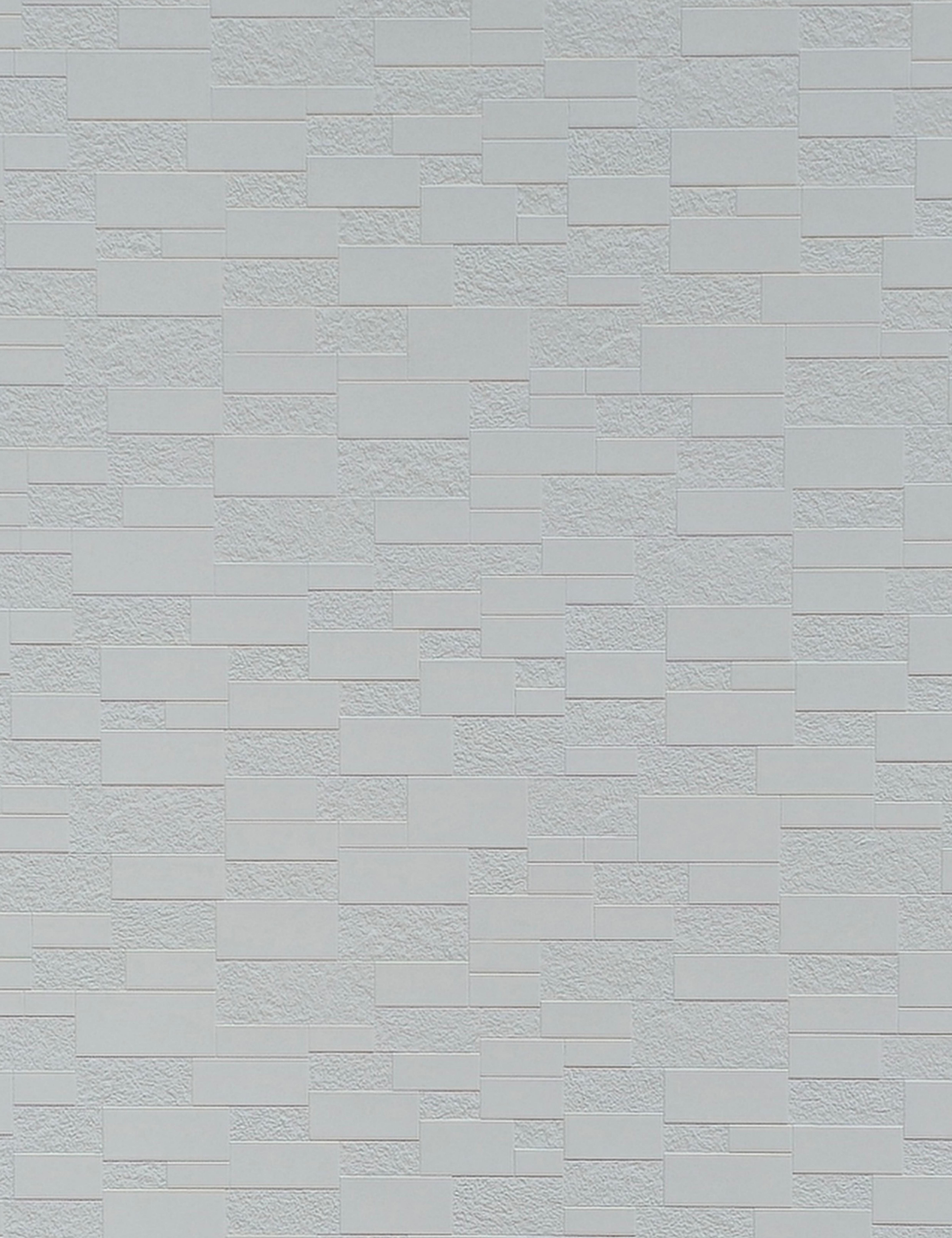 White textured wall panel with a brick pattern and rough surface finish.