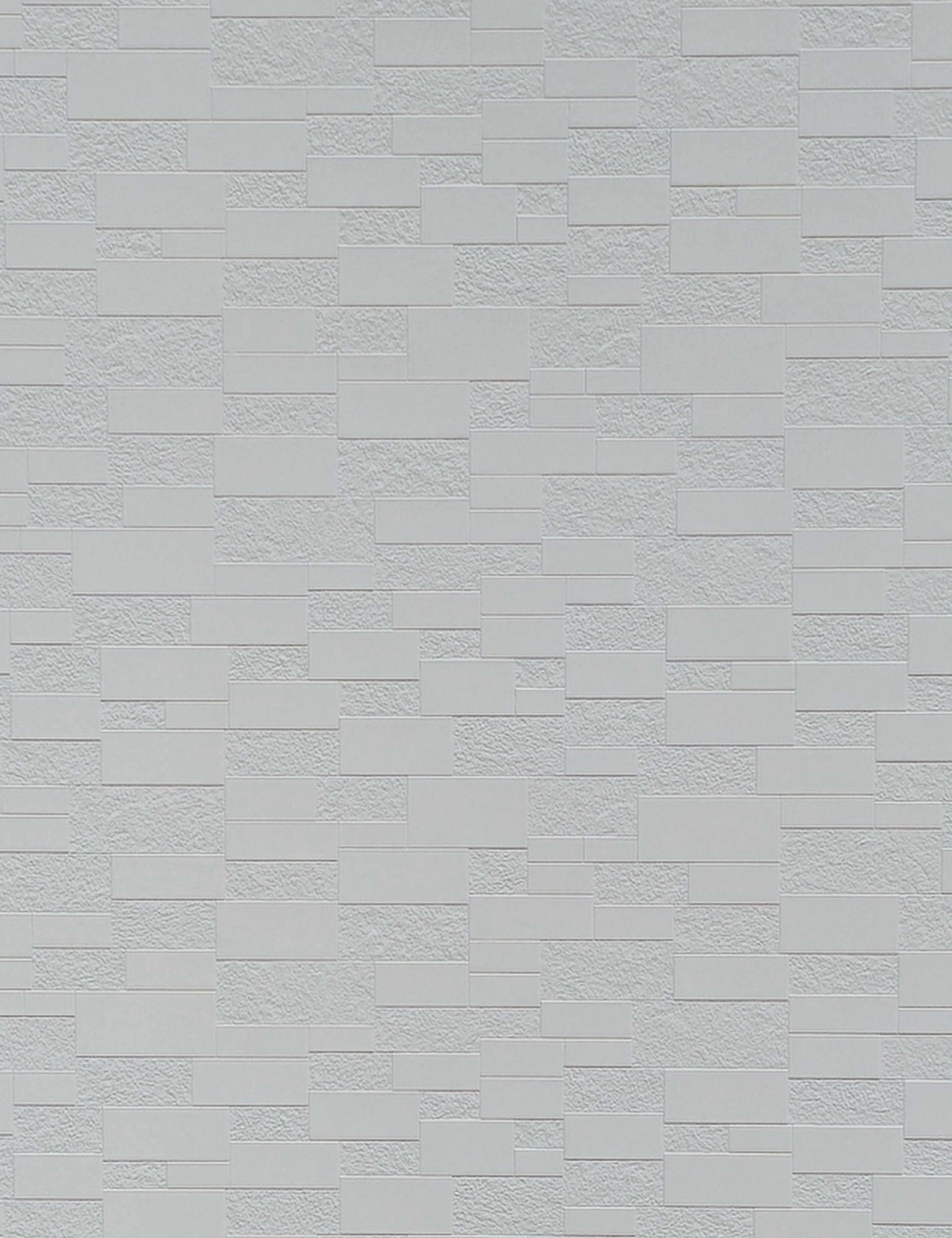 White textured wall panel with a brick pattern and rough surface finish.