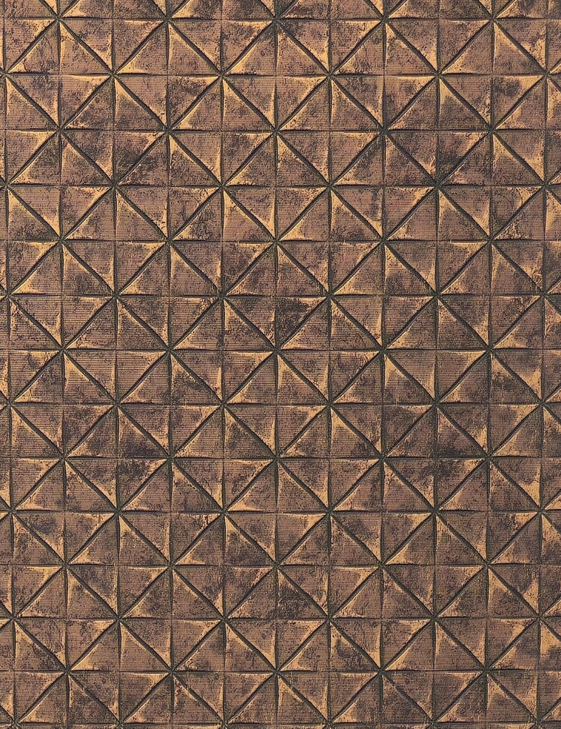 Brown textured wall panel with geometric triangular pattern and distressed finish.