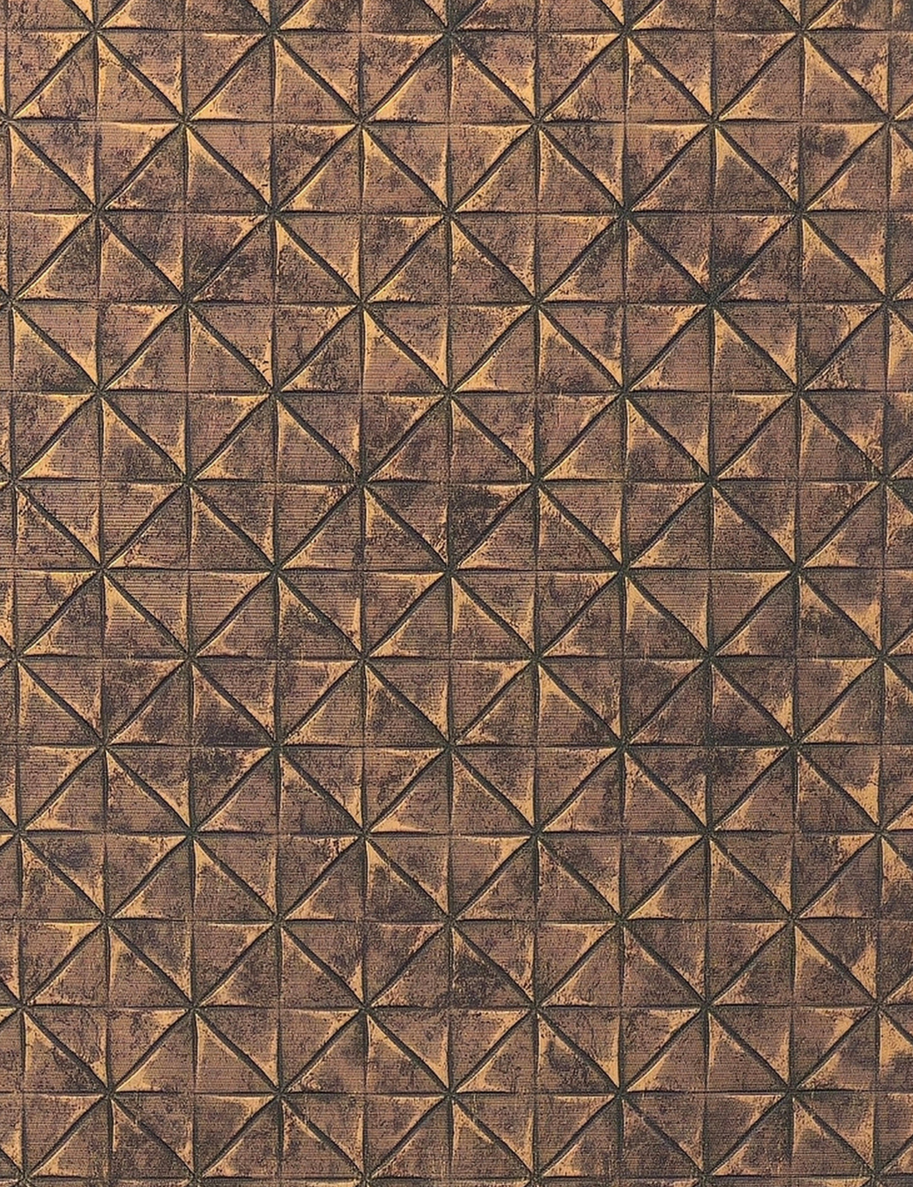 Brown textured wall panel with geometric triangular pattern and distressed finish.