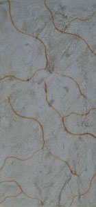 Grey marble wall panel with textured finish and orange veining pattern, showcasing stone appearance and rough surface detail.