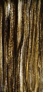 Brown textured marble wall panel with stone pattern and vertical grain visible in close-up view