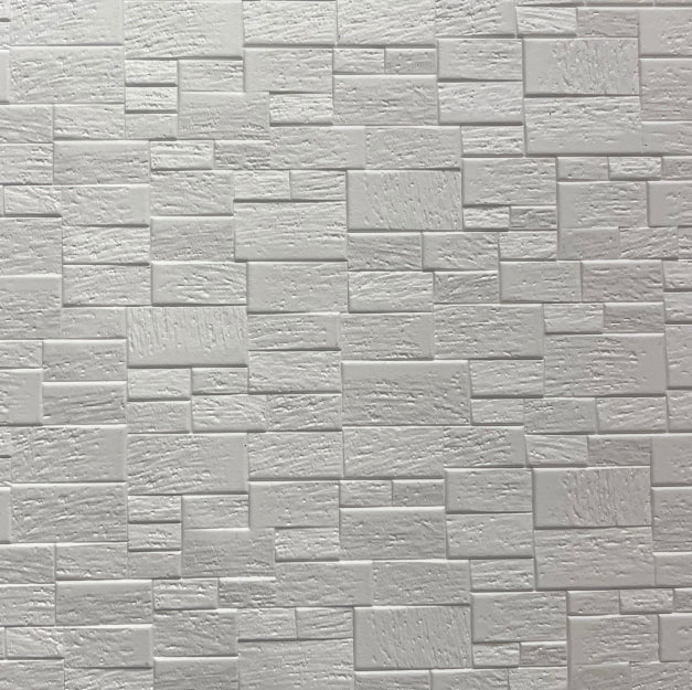 White textured designer wall panel with brick pattern and rough finish, showing rectangular tiles in varying sizes and