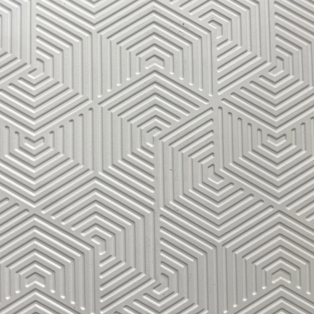 White textured wood louver panel with geometric pattern and embossed design, showing layered lines and chevron shapes.