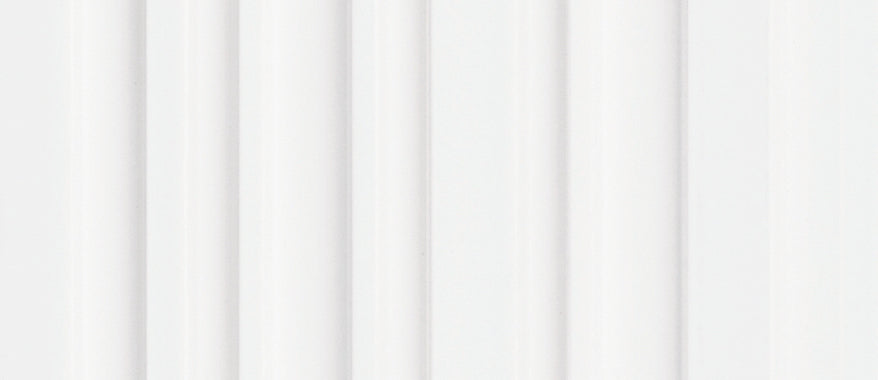 White fluted wall panel with textured finish and vertical grooves, showing a smooth and even surface.