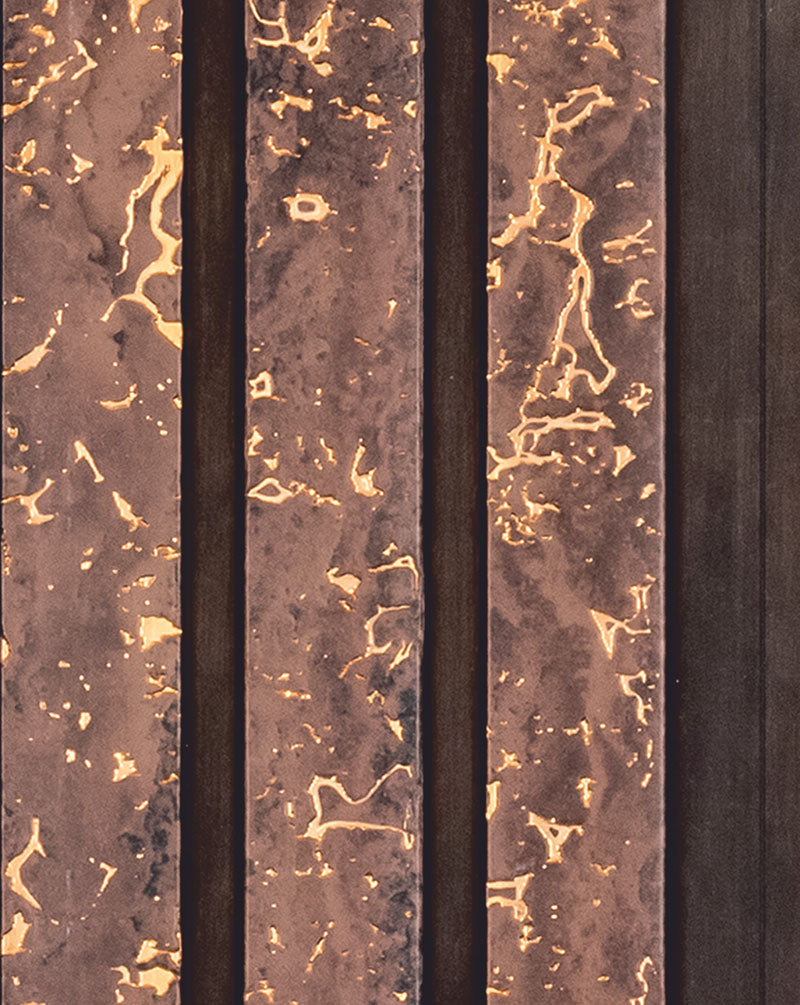 Brown marble wall panel with textured finish and gold veining, featuring vertical slats with varying marble patterns and