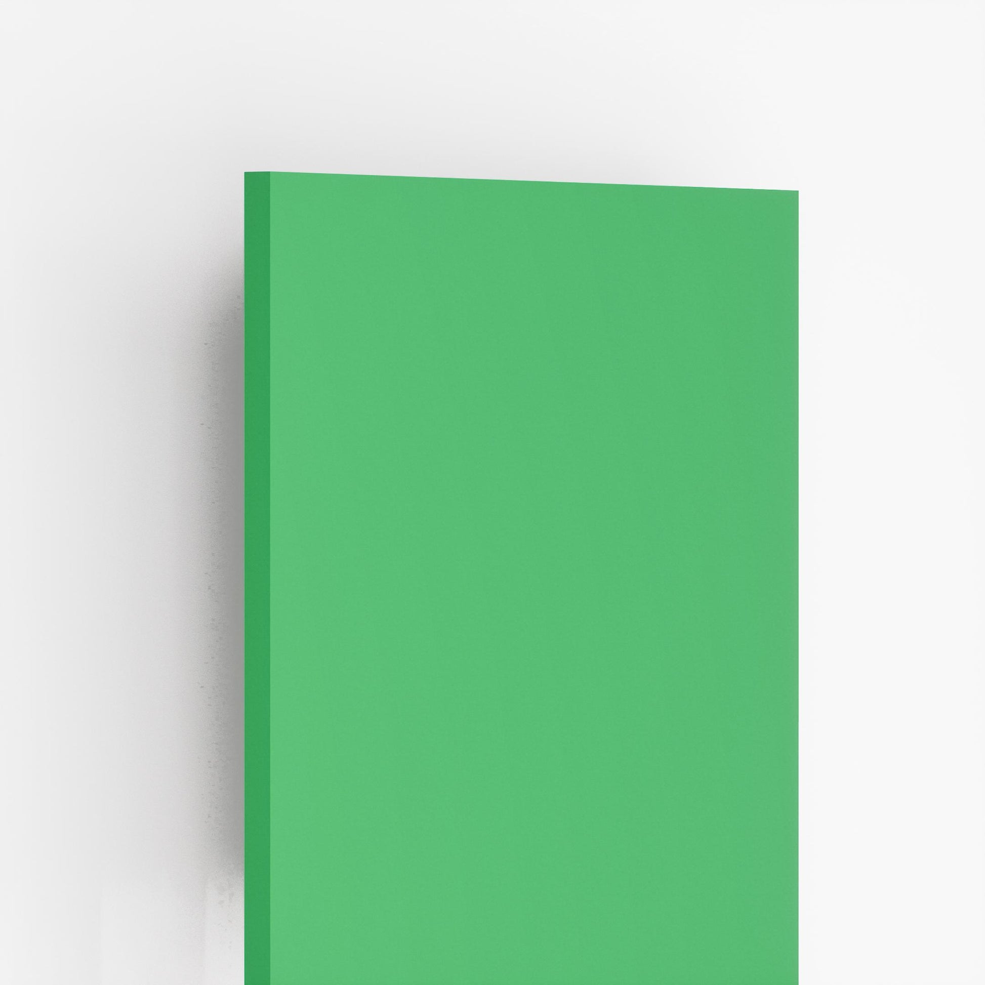 Glossy green plain laminate sheet with smooth finish and visible edge against white background