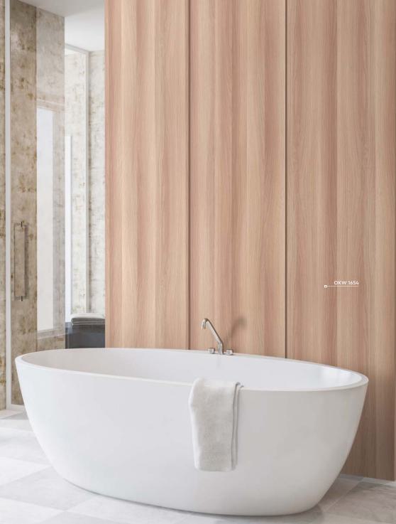 Brown wood grain laminate wall with textured finish in modern bathroom setting with white bathtub and marble accents