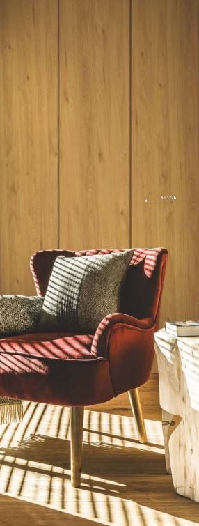 Brown wood grain laminate with suede finish, visible texture and grain, used as wall paneling in a cozy interior setting