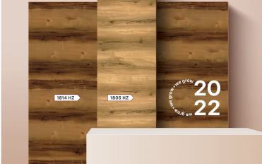 Brown wood laminate texture with horizontal grain and texture finish, displayed on wall with product code labels and 2022