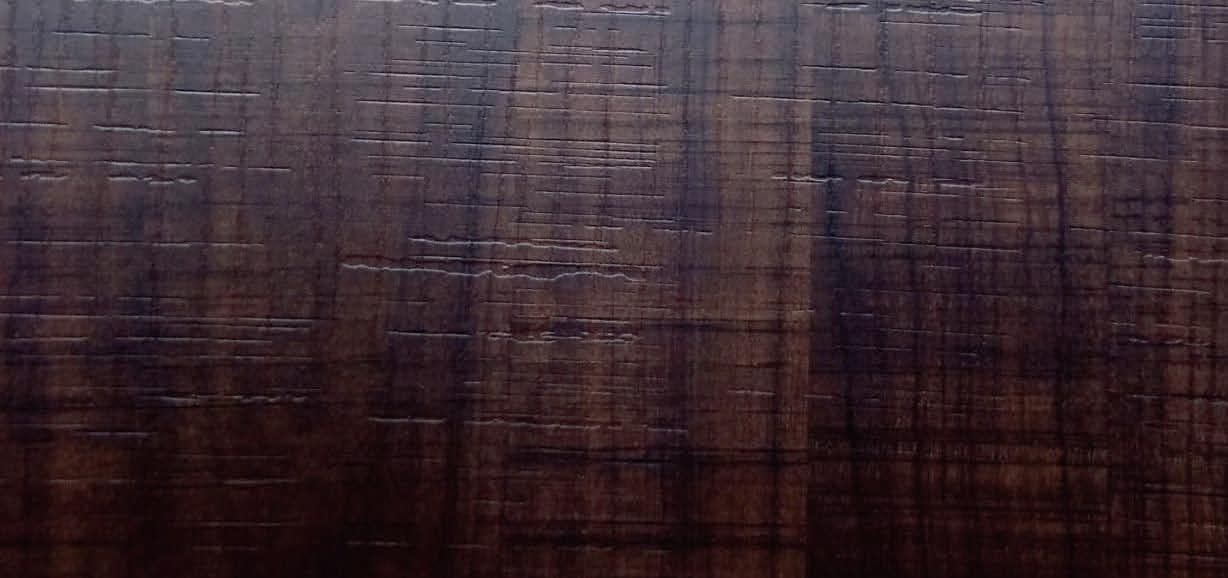 Brown wood laminate with textured finish and wood grain pattern, showing vertical lines and embossed texture details.