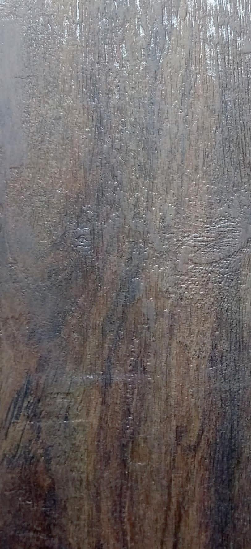 Dark brown wood grain laminate with textured finish and visible wood pattern and grain details