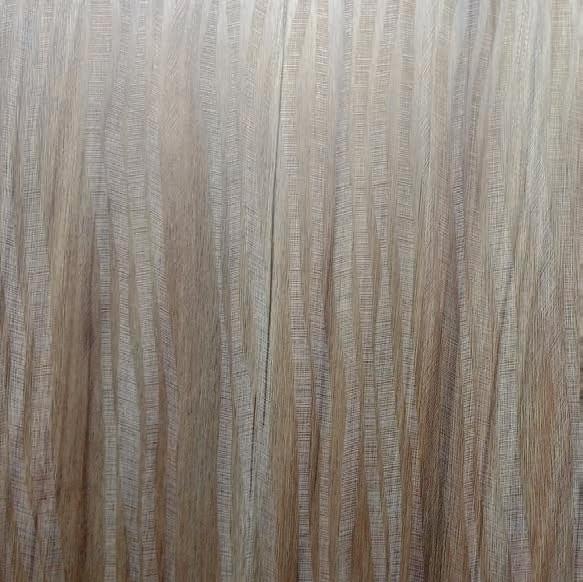 Grey wood grain laminate with textured finish and vertical grain pattern, showing wood-like appearance and subtle texture
