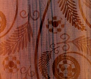 Brown wood grain laminate with textured finish and embossed leaf pattern, showing detailed wood appearance and texture.
