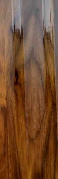 Brown wood grain laminate with textured finish and glossy sheen displaying African wood pattern and natural wood variations
