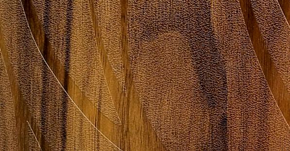 Brown wood grain laminate with textured finish and striped pattern, showing wood-like appearance and rough surface details.