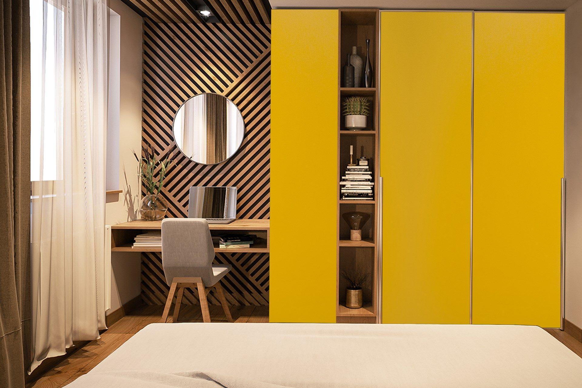 Yellow suede laminate wardrobe doors and shelves in a modern bedroom with geometric patterned wall and wooden accents.