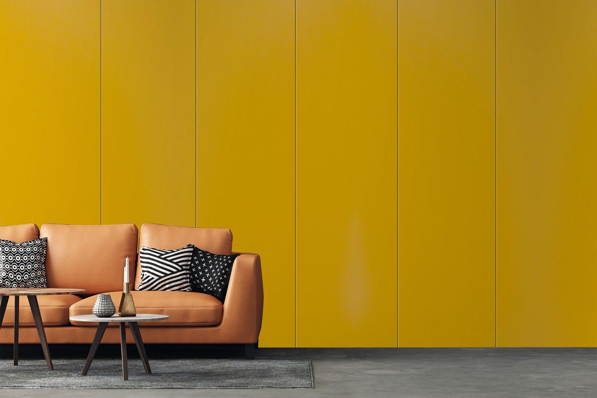 Yellow suede laminate wall panels with subtle texture and vertical seams in a modern living room setting.