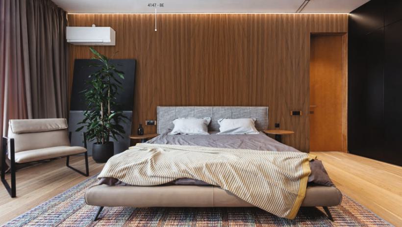 Brown wood grain laminate wall with texture finish in modern bedroom setting, showcasing wood pattern and vertical grain