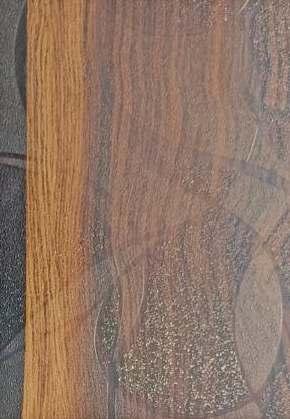 Brown wood grain laminate with textured finish showing natural wood pattern and varying shades of brown tones and wood