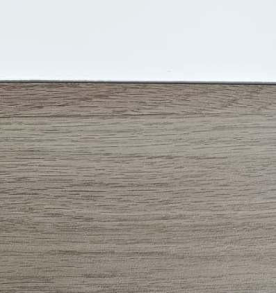 Grey wood grain laminate with suede finish and textured surface showing wood pattern and subtle grain details