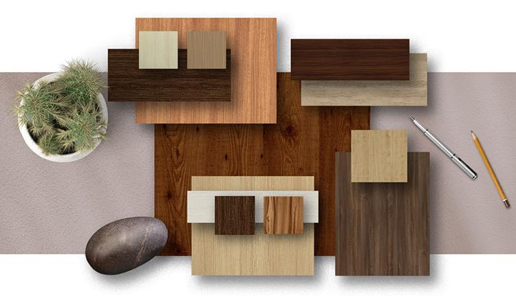 Brown wood laminate samples with suede finish and wood grain texture displayed with decorative items and stationery.