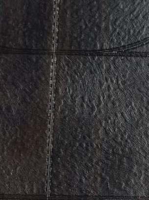 Dark wenge wood laminate with textured finish and visible wood grain pattern, showing joined sheets with subtle seam.