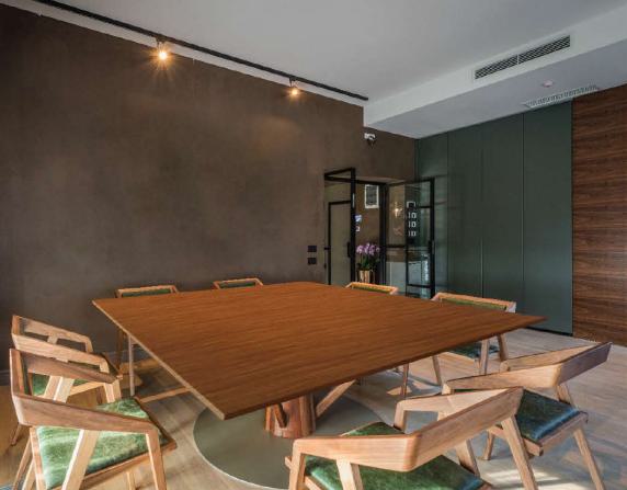 Brown wood laminate with wood grain texture and suede finish on a table in a modern conference room setting