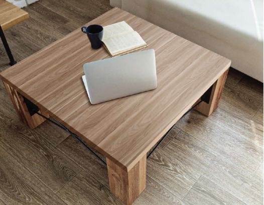 Brown wood grain laminate with suede finish on a coffee table surface showing visible wood texture and grain pattern