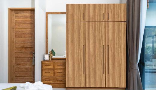 Brown wood laminate with suede finish and wood grain texture used in bedroom furniture including wardrobe and dresser