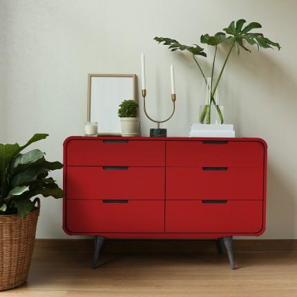 Red suede laminate dresser with black handles and tapered legs, plain color finish, decorative items on top