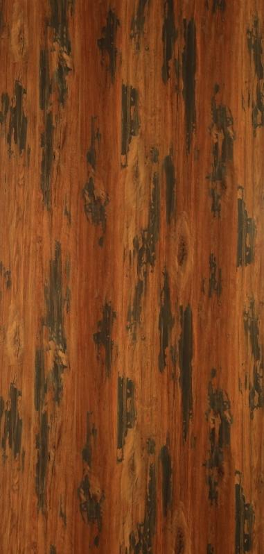 Brown wood laminate with suede finish, visible wood grain and texture, dark brown spots and streaks throughout the surface.