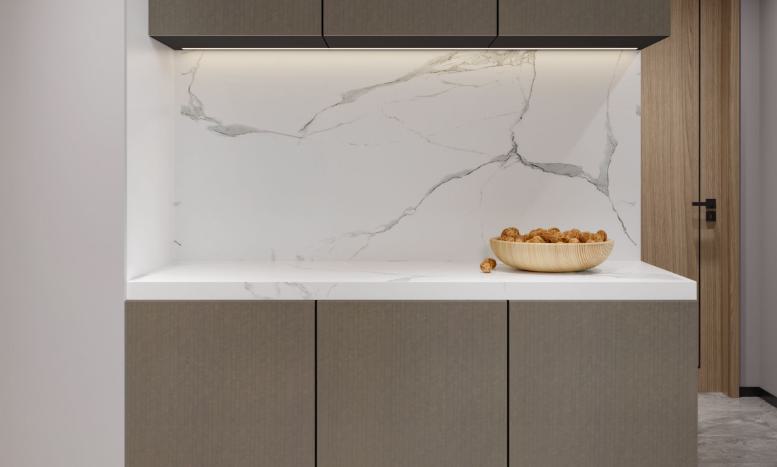 Brown wood laminate with textured fishbone pattern and visible grain, used on modern kitchen cabinets with marble countertop