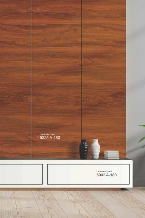 Brown wood grain laminate with textured finish and visible wood pattern on a cabinet surface with decorative vases.