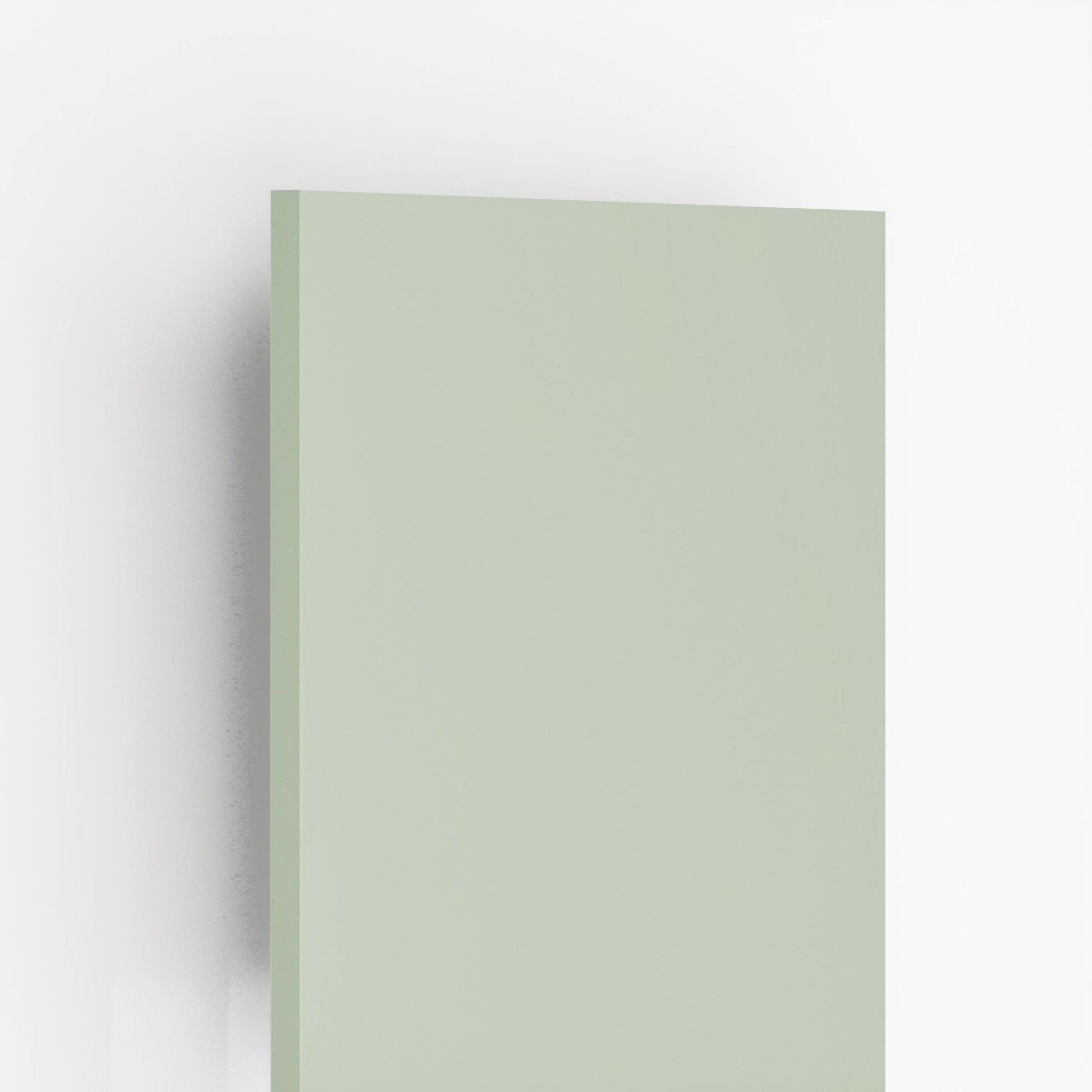 Plain green suede laminate sheet with matte finish and smooth texture, showing edge detail and subtle shadow effect