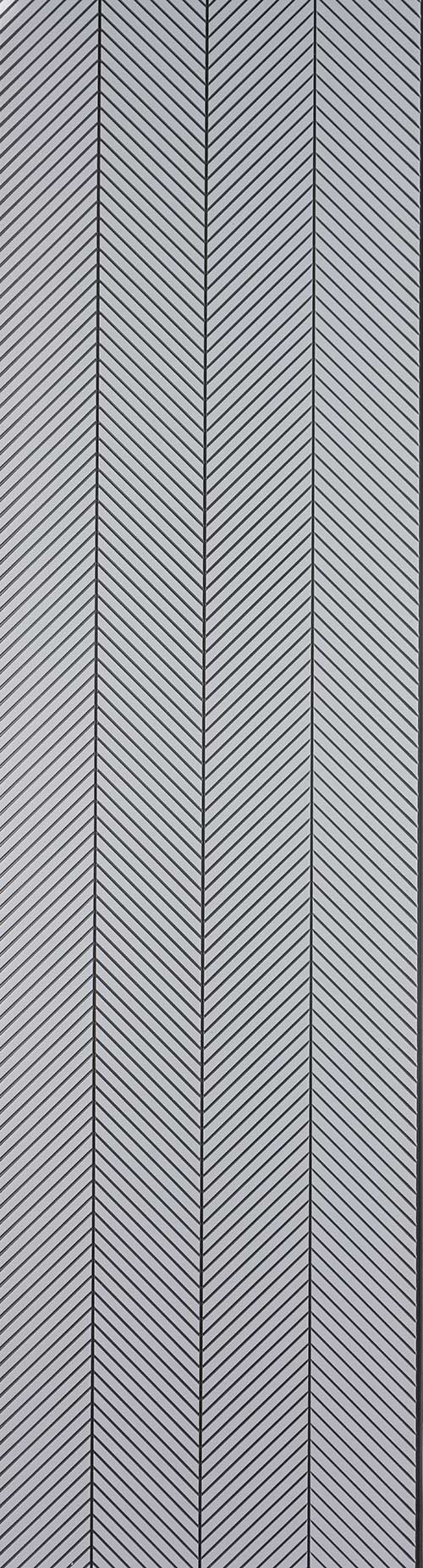 Grey fluted wall panel with matte finish and chevron pattern, showing diagonal lines and vertical grooves.