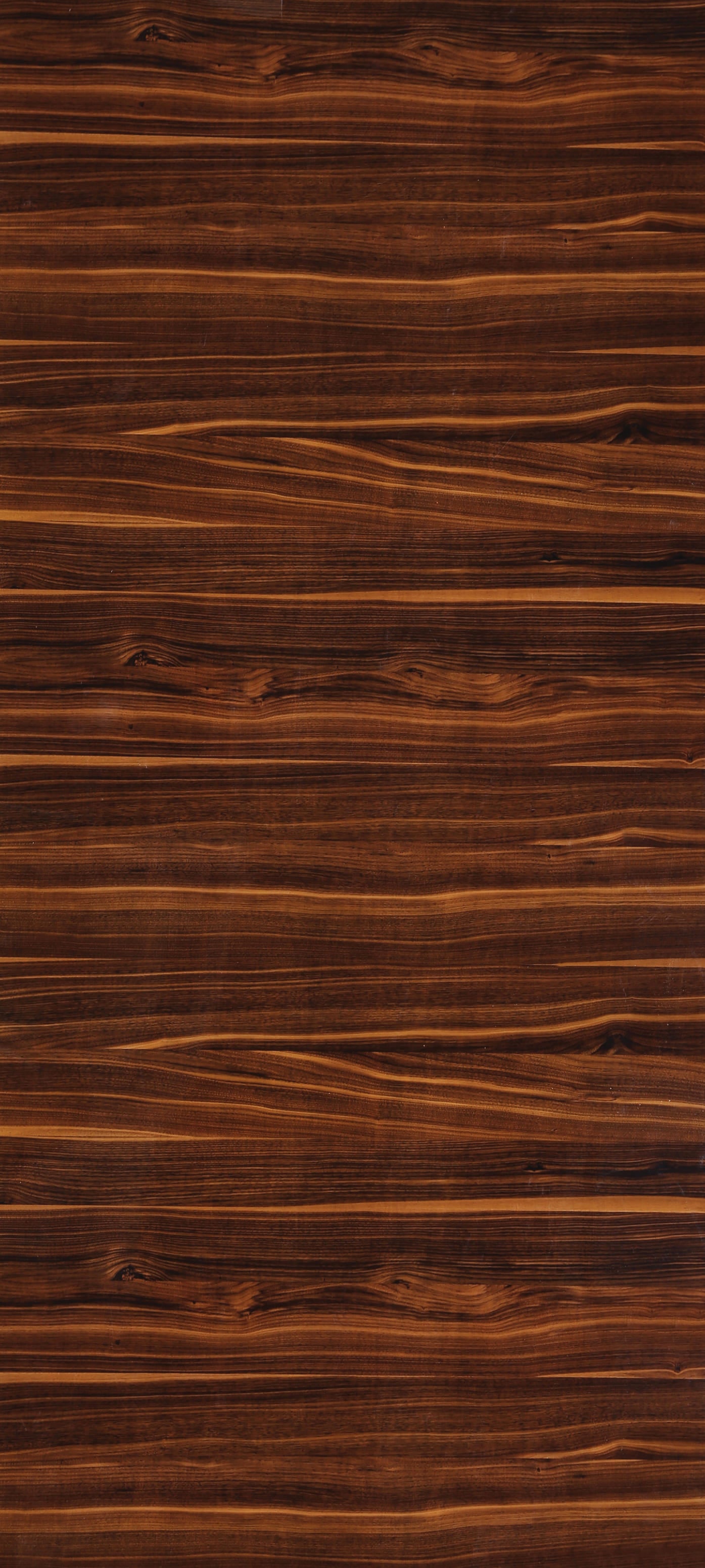 Brown wood grain laminate with high gloss finish and wavy pattern, showing wood texture and grain details.