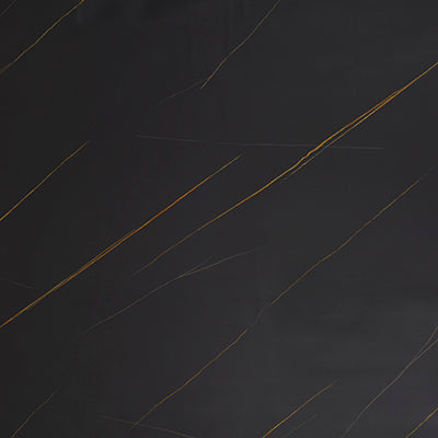 Black marble laminate with golden veins and high gloss finish showing diagonal pattern and smooth texture.