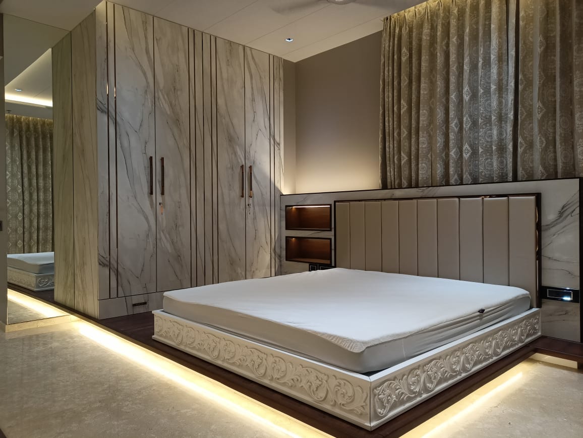 Marble laminate wall and closet in modern bedroom with beige bed frame and patterned curtains, showing matte finish and