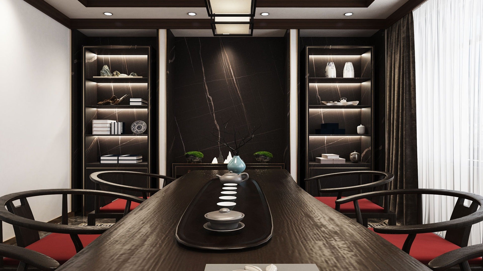 Black marble laminate wall with white veining in a modern dining room with dark wood furniture and red cushions.