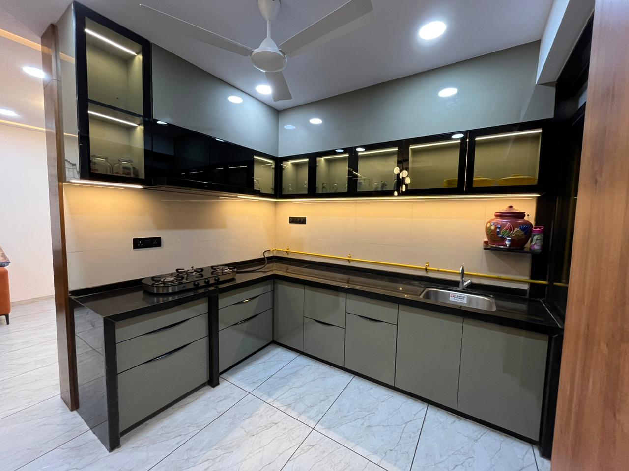 Brown wood laminate kitchen cabinets with matte finish and visible wood grain texture in a modern kitchen setting.