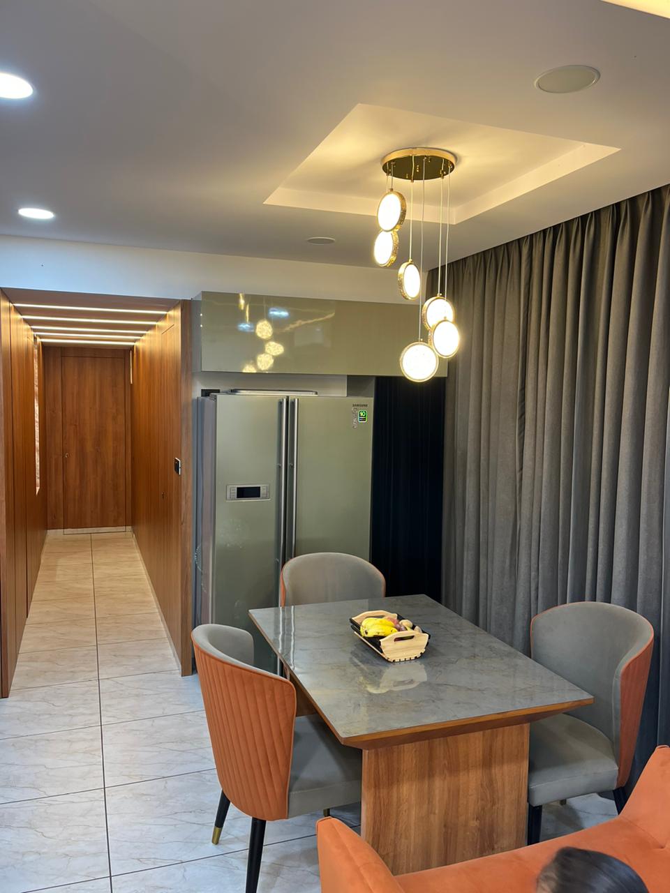 Brown wood laminate in modern dining area with matte finish and wood grain texture on furniture and wall paneling