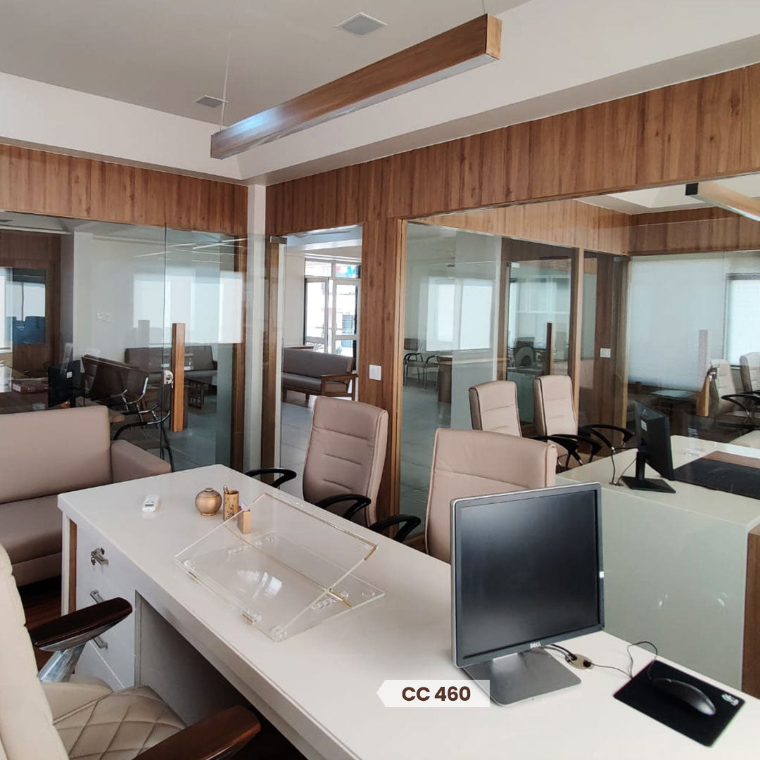 Wood paneling on office walls and furniture, with glass partitions and modern decor, showcasing decorative laminate in a